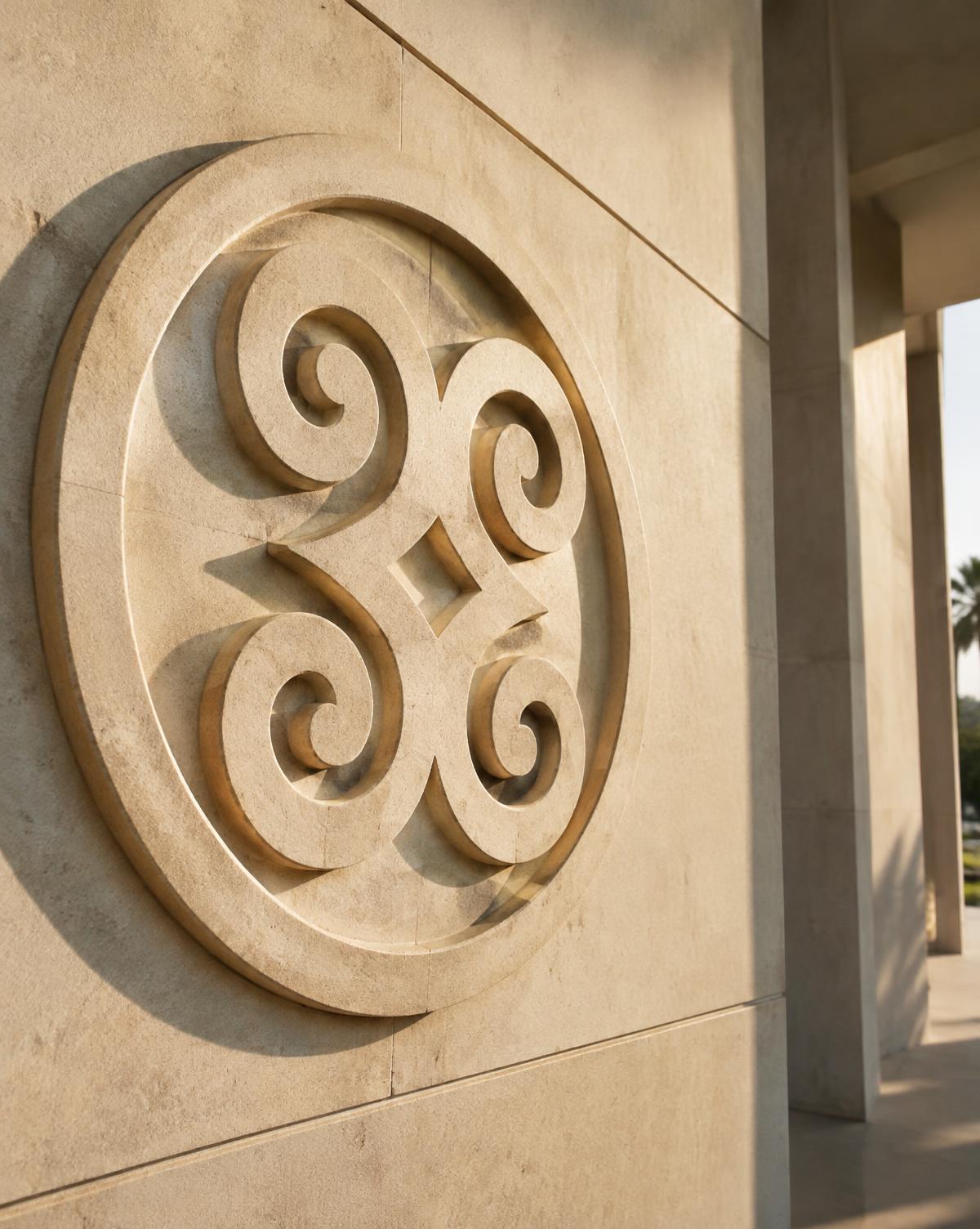 Carved Adinkra relief on a stone facade